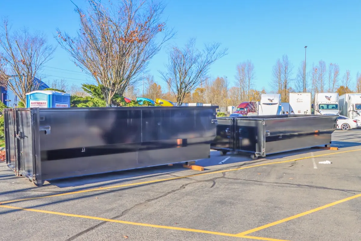 Professional dumpster rental service with roll-off container on residential driveway in Darnestown